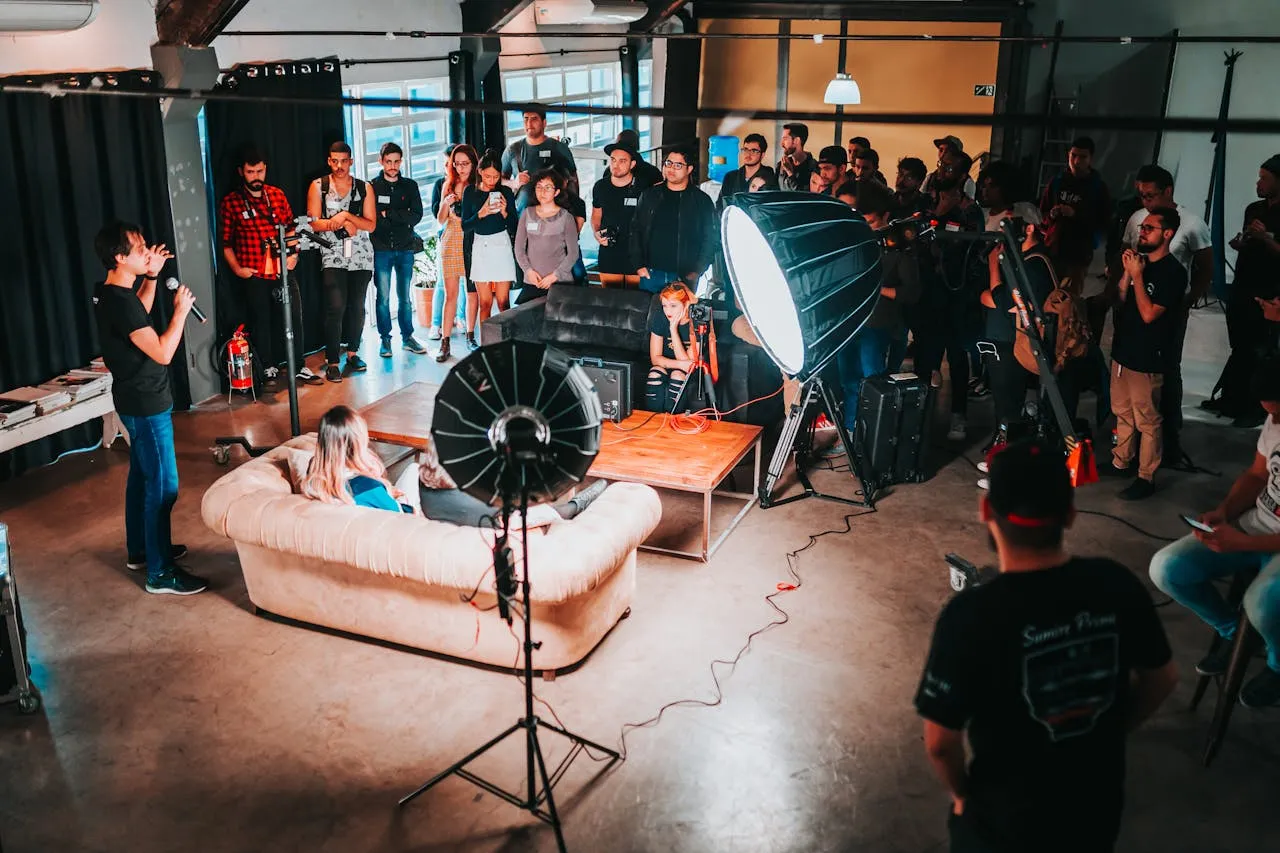 A crowd gathered around a portrait lighting setup during a community shoot
